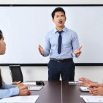 **Image:** A confident professional giving a presentation to colleagues. Focus on clear communication and positive body language. The setting should be a modern office in Vietnam, with colleagues nodding in agreement.